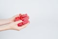 Woman hands holding red gift with ribbon, manicured hands with nail polish on white background with copy space Royalty Free Stock Photo