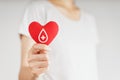 Woman hands holding red heart with blood donor sign. healthcare, medicine and blood donation concept