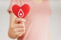 Woman hands holding red heart with blood donor sign. healthcare, medicine and blood donation concept Royalty Free Stock Photo