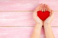 Woman Hands Holding Red Heart on Pink Wooden Background - Health care, Love Royalty Free Stock Photo