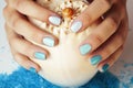 Woman hands holding sea shell and sea salt with manicured nails Royalty Free Stock Photo