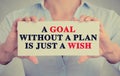 Woman hands holding sign with a goal without plan is just wish message Royalty Free Stock Photo