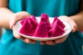 Woman hands holding sliced red dragon fruit Royalty Free Stock Photo