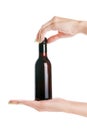 Woman hands holding small wine bottle. Isolated with clipping pa Royalty Free Stock Photo