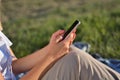 Connected and Relaxed: Woman Enjoying Nature with Smartphone in Hand Royalty Free Stock Photo