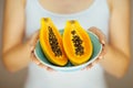 Woman hands holding some papayas, sensual studio shot