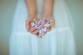 Woman hands holding some vintage candy, sensual rural studio shot