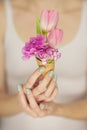 Woman hands holding spring flowers in an ice cream cone, sensual studio shot Royalty Free Stock Photo