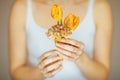 Woman hands holding spring flowers in an ice cream cone, sensual studio shot Royalty Free Stock Photo