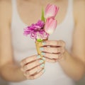 Woman hands holding spring flowers in an ice cream cone, sensual studio shot Royalty Free Stock Photo