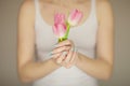 Woman hands holding spring flowers in an ice cream cone, sensual studio shot Royalty Free Stock Photo