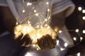 Woman hands holding string of lights in the dark Royalty Free Stock Photo