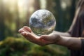 Woman hands holding transparent earth globe over blurred background. Generative AI Royalty Free Stock Photo
