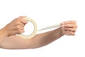 Woman hands holding and using a masking tape
