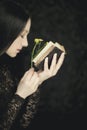 Woman hands holding vintage old book, very dark atmospheric sensual rural, gothic studio shot