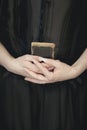 Woman hands holding vintage old book, very dark atmospheric sensual rural, gothic studio shot