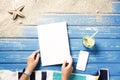 Woman hands holding white blank magazine on beach towel Royalty Free Stock Photo