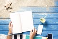 Woman hands holding white blank magazine on beach towel Royalty Free Stock Photo