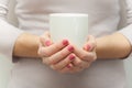 Woman hands holding white cup of tea or coffe Royalty Free Stock Photo