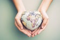 Woman hands holding a world globe in heart shape. Flat lay, top view. Generative AI Royalty Free Stock Photo