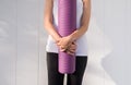 Women hands holding yoga mat purple color after a workout in the morning,Exercise equipment,Healthy fitness and sport concept,Copy Royalty Free Stock Photo