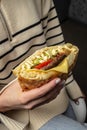 Woman hands holds doner kebab. Fast food take away. copy space