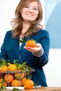 Woman hands with iron basket with fresh clementine copy space