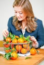 Woman hands with iron basket with fresh clementine copy space