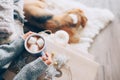 Woman hands ith cup of hot chocolate close up image, cozy home,