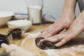 Woman hands kneading chocolate dough, cooking cookies or dessert. Cooking at home Royalty Free Stock Photo