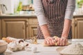 Woman hands kneading dough on kitchen table Royalty Free Stock Photo