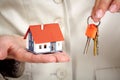 Woman Hands with little house and key. Royalty Free Stock Photo