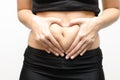 Woman hands make heart shape on stomach Royalty Free Stock Photo