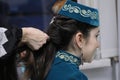 Woman hands making the tight braid of little girl dressed in national Crimean Tartar costume. Kyiv, Ukraine