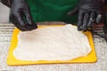 Woman hands making yeast dough on a board. Street market. Preparation of dough at the festival of street food