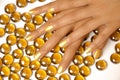 Woman hands manicure with gold nail polish