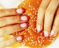 Woman hands with manicure holding hamburger and french fries iso Royalty Free Stock Photo