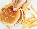 Woman hands with manicure holding hamburger and Royalty Free Stock Photo