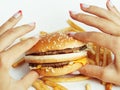 Woman hands with manicure holding hamburger and Royalty Free Stock Photo