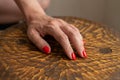 Woman hands with manicured red nails closeup. Skin and nail care. wooden background Royalty Free Stock Photo