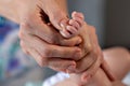 Woman hands massaging baby leg