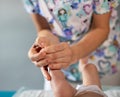 Woman hands massaging baby leg