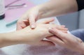 Woman hands in a nail salon receiving a hand massage by a beaut Royalty Free Stock Photo