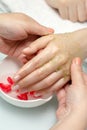 Woman hands in a nail salon receiving a  hand massage by a beautician. SPA manicure Royalty Free Stock Photo