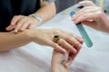 Woman hands in a nail salon receiving a manicure by a beautician Royalty Free Stock Photo