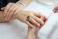 Woman hands in a nail salon receiving a manicure by a beautician Royalty Free Stock Photo