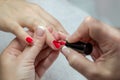 Woman hands in a nail salon receiving a manicure by a beautician Royalty Free Stock Photo