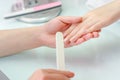 Woman hands in a nail salon receiving a manicure.  Nail filing. Royalty Free Stock Photo