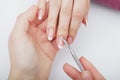 Woman hands in a nail salon receiving a manicure procedure. SPA Royalty Free Stock Photo