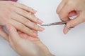 Woman hands in a nail salon receiving a manicure procedure. SPA Royalty Free Stock Photo